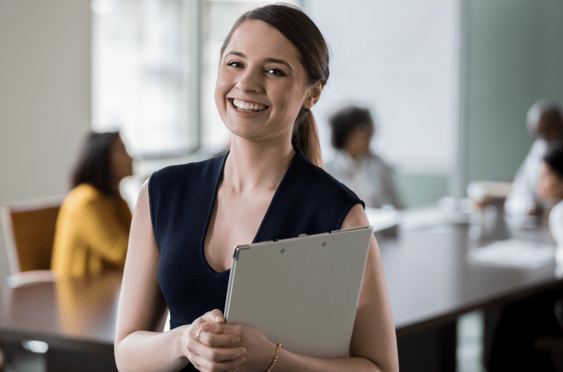 Portrait of cheerful administrative assistant before meeting